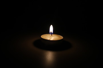 burning candle tablet in the dark