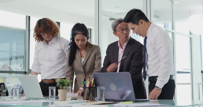 Senior Businessman try to assign work with team at office. He explain project with serious emotion. Business and Coworker concept.