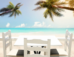 Table background with beautiful blue ocean and sandy beach view. Summer sunny day.