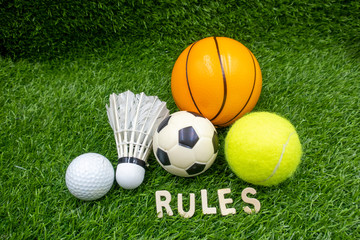Naklejka premium golf ball shuttlecock football basketball and tennis with rules are on green grass