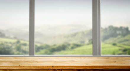 Table background and spring time. Green nature in blurred view in distance. Empty space for decoration and an advertising product.