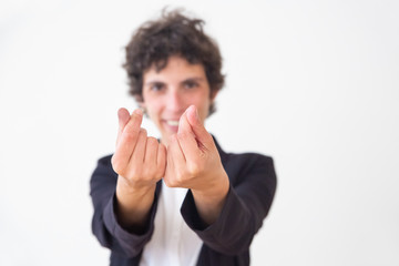 Smiling woman gesturing for money. Close-up view of happy middle aged businesswoman showing money sign isolated on white background. Gesture concept