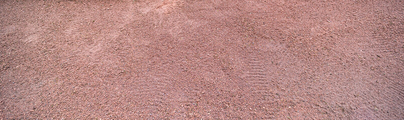 Long horizontal red sand surface with shoe prints