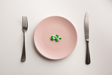 Medical capsules on a plate. Flat lay.