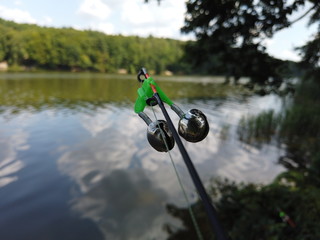 Fishing on the forest lake. Bells on spinning while fishing.