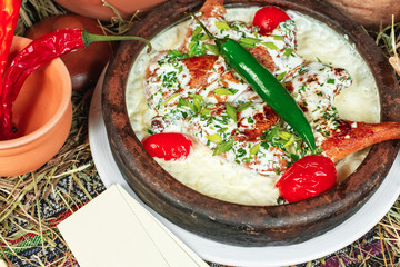 Creamy milk soup with pepper, chicken, herbs and tomatoes in Georgian style. National cuisine