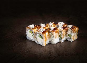 Portion of Japanese-Style Rolls with Soft Cheese and Cucumber on a Dark Background Copy Space