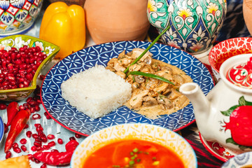 Chicken fricassee with mushrooms, onion and cream sauce, served with garnish rice.