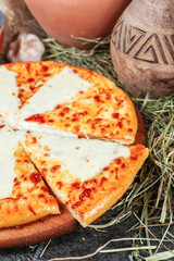 Georgian national dish with cheese, butter and herbs - khachapuri. Baked diced dough with spices and cheese, appetizer in Georgian style. National cuisine