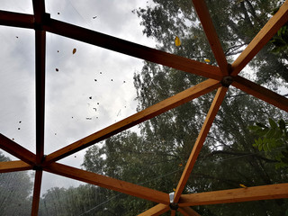 Wooden frame construction and cellophane roof with summer rain drops