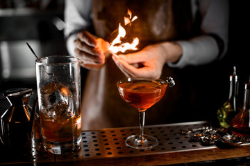 Close-up of bartender firing up a match
