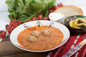 Top view of plate with meatballs soup, traditional plate of the Romanian cuisine, ciorba de perisoare