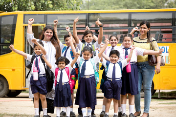 Group of school children with teachers celebrating success