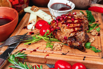 steak of horse meat fried on coals. Grilled meat, with greens, cheese sticks, tomato sauce and nuts with balsamic sauce, Georgian appetizer. National cuisine