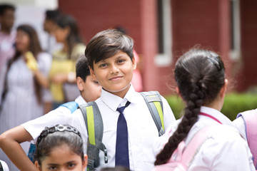 Group of schoolboys and schoolgirls at school campus