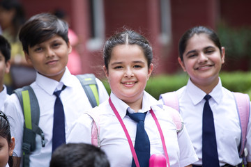 Group of schoolboys and schoolgirls at school campus