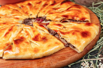 National Georgian meat pie. oven-baked dough with cheese, meat, potatoes and aromatic spices. National cuisine