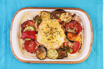 Mediterranean dish, Georgian recipe. Baked chicken steak with lemon, vegetables, pepper, zucchini, eggplants and grilled tomatoes with spices