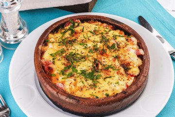 European cuisine, Mediterranean dish. Stew of meat, vegetables and seafood, baked in a pot under a...