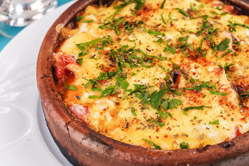 European cuisine, Mediterranean dish. Stew of meat, vegetables and seafood, baked in a pot under a...