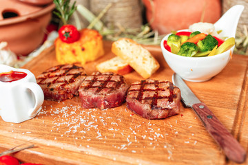 Grilled veal medallions with sauces served with steamed vegetables - cauliflower, broccoli, carrots, tomatoes and mashed potatoes according to the Georgian recipe. National cuisine