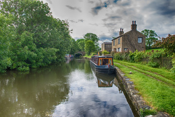 Narrowboat on a British canal in rural setting
