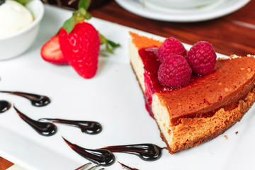 Homemade cheesecake with fresh raspberries and mint for dessert