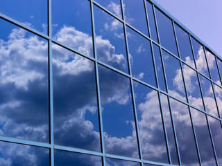 blue sky reflection in windows of building