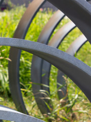 vertical view of rusty arch-curved metal and grass