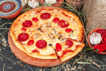 National pizza with salami, tomatoes, mushrooms, mozzarella cheese and Georgian corn. National cuisine