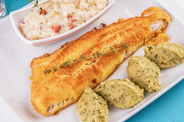 Fried fish steak carp served with greens, chili pepper, boiled rice, rosemary, thyme and mashed potatoes with dill according to the Georgian recipe. Mediterranean Kitchen