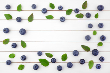 Framework made of blueberry on white wooden background. Flat lay. Food concept.