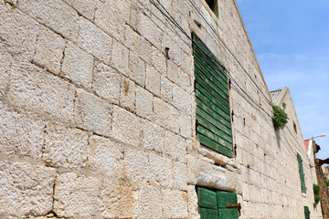 Fototapeta na wymiar Rustic detail of historic salt warehouse in town Pag, on island Pag, Croatia.