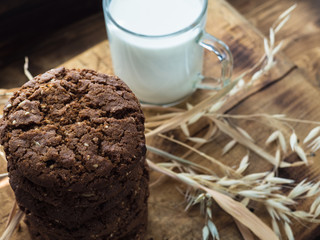 oatmeal cookies oats and milk on a wooden background