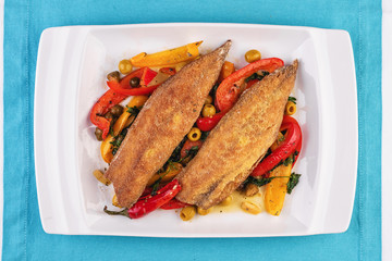  Grilled fish steak carp served with stewed chili peppers, olives, olives, greens and green pepper according to the Georgian recipe. Mediterranean Kitchen