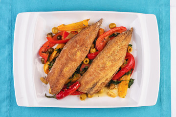  Grilled fish steak carp served with stewed chili peppers, olives, olives, greens and green pepper according to the Georgian recipe. Mediterranean Kitchen