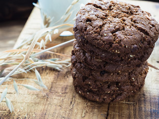 oatmeal cookies oats and milk on a wooden background