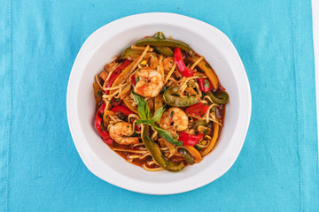 Mediterranean dish, Georgian recipe. Pasta with shrimps, red and green pepper, basil