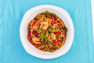 Mediterranean dish, Georgian recipe. Pasta with shrimps, red and green pepper, basil