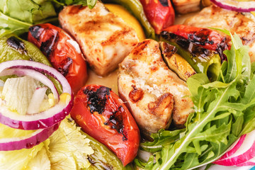  Seafood, Mediterranean cuisine, European dish. salad of assorted fish pieces grilled, with grilled vegetables - with onion rings, red and green pepper, chili pepper, greens, cheese, mushrooms 