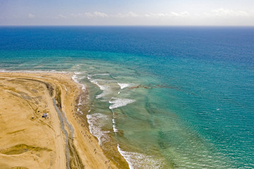 Aerial view of sandy seashore. Sunny beach at the seaside in summer.