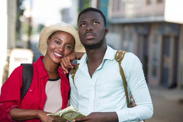 young tourist couple with geographical map.