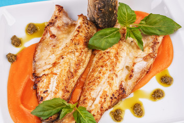  Sea fish steak with basil and green pepper on a pumpkin puree pillow according to the Georgian recipe. Mediterranean cuisine