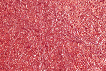 Rose gold foil shiny texture, abstract red wrapping paper for background and design art work.