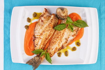  Sea fish steak with basil and green pepper on a pumpkin puree pillow according to the Georgian recipe. Mediterranean cuisine