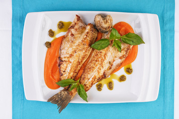  Sea fish steak with basil and green pepper on a pumpkin puree pillow according to the Georgian recipe. Mediterranean cuisine