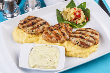  Fried fish patties served with vegetables, salad and greens and mashed potatoes according to Georgian recipe