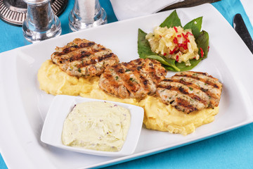  Fried fish patties served with vegetables, salad and greens and mashed potatoes according to Georgian recipe