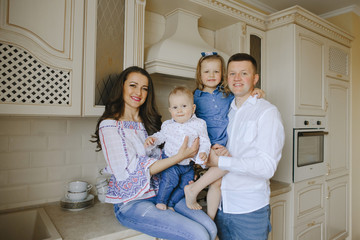 happy family with two children in the kitchen