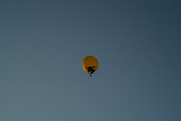 Hot air balloons high in the air. European balloon festival in Spain. Free flow of big colourful balloons flying in the event sky. Beautiful landscapes and evening light. Summer adventures in Spain 